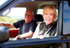 Smiling senior couple enjoying a car ride - Road trip