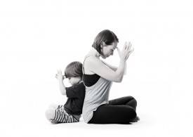 Caregiver and child doing yoga