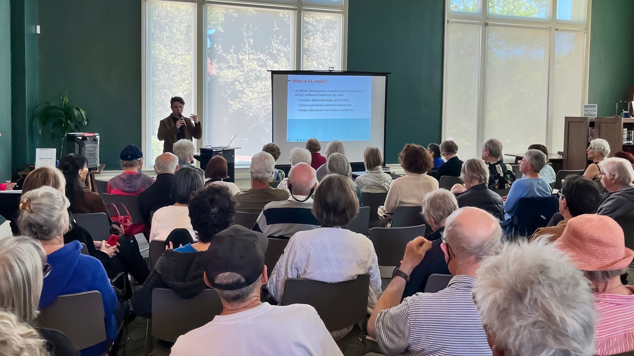 Large audience watching presentation of AI Basics
